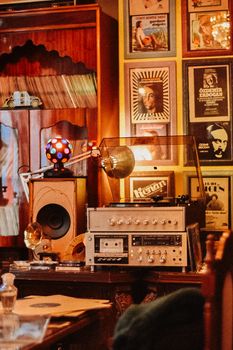 A nostalgic music room with vintage audio devices, records, and retro decor.
