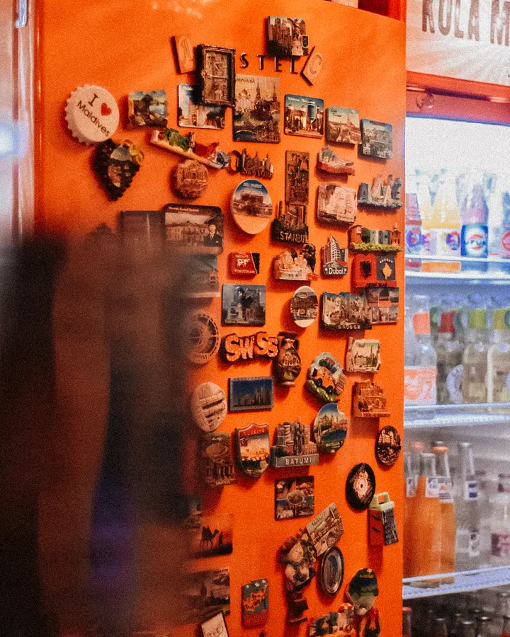 Kenmore refrigerator repair in La Mesa, CA Magnets on a refrigerator door next to a stocked fridge, Kenmore refrigerator repair in La Mesa