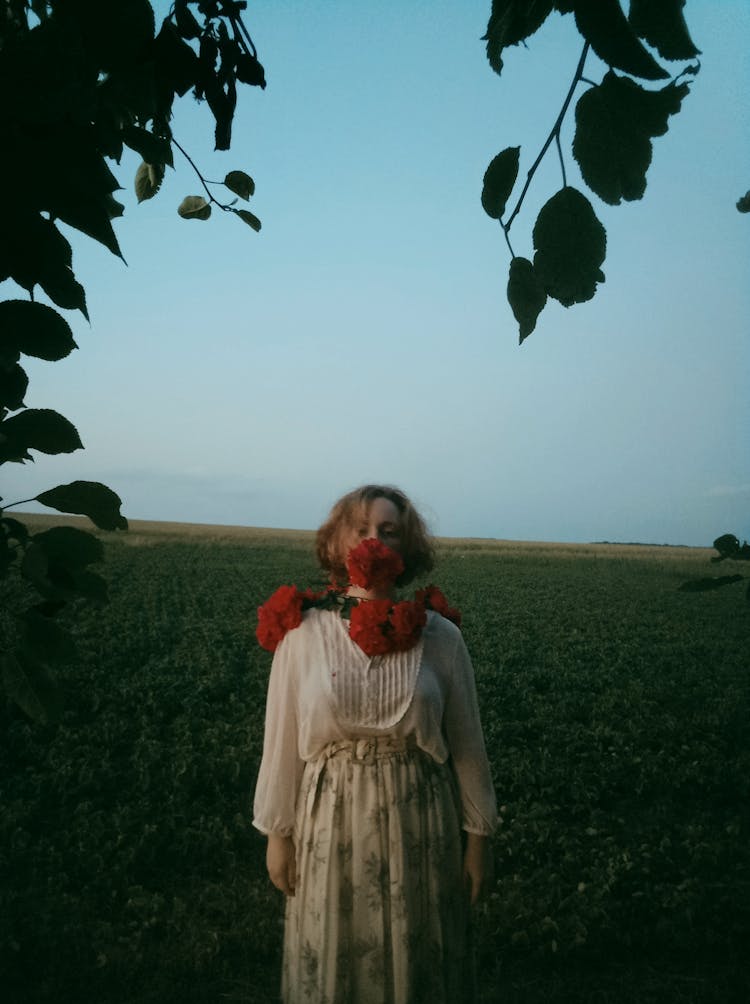 Woman In Retro Clothing And Flowers Posing In Field