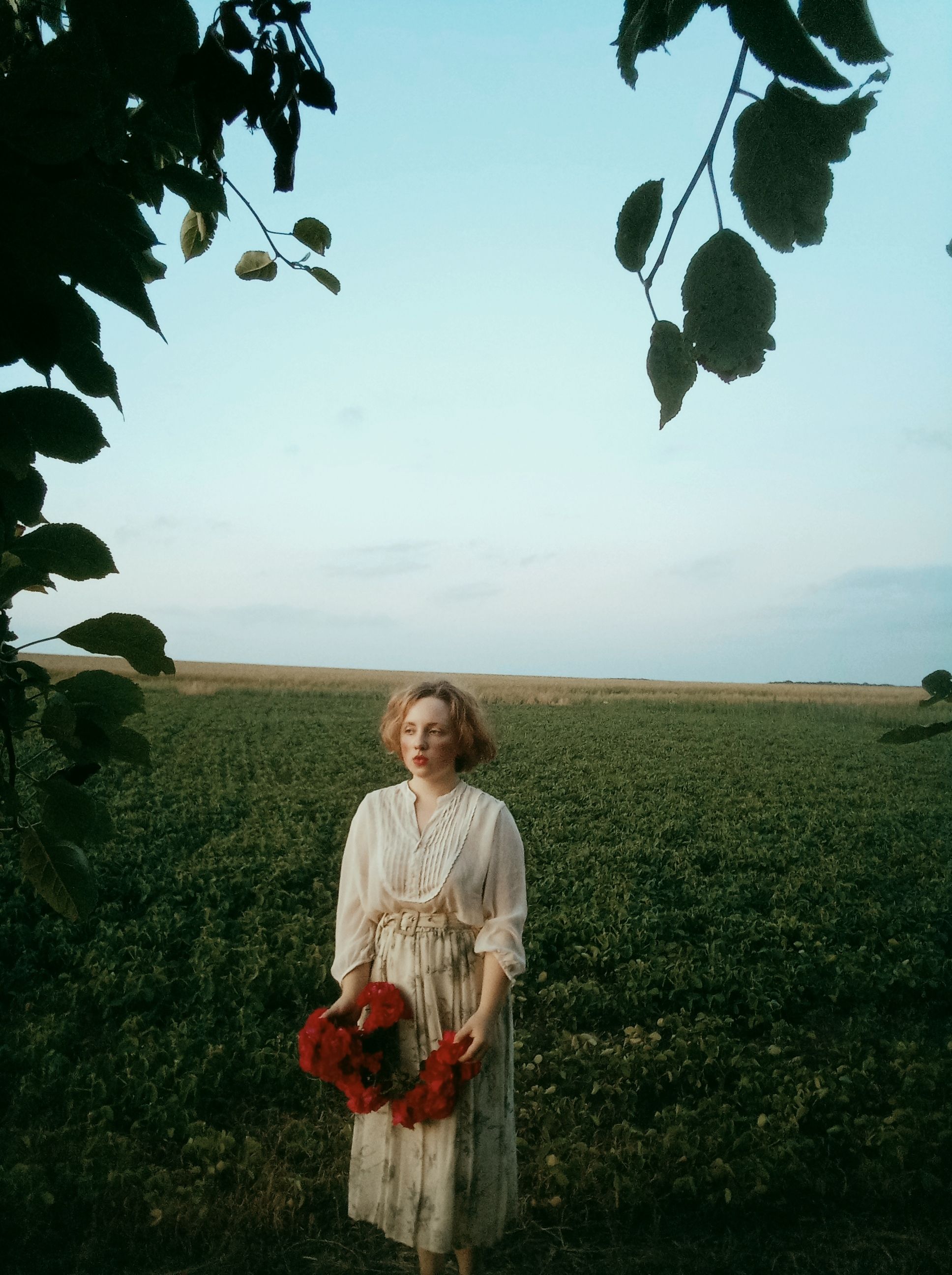 Woman in White Dress Standing on Green Grass Field while Holding Red ...