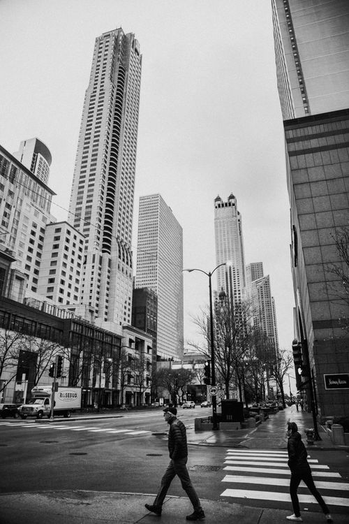 Free Monochrome view of pedestrians on a Chicago street with iconic skyscrapers. Stock Photo