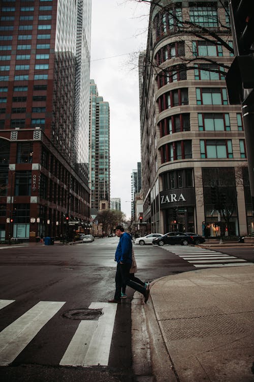 A Man Walking on the Pedestrian Crossing