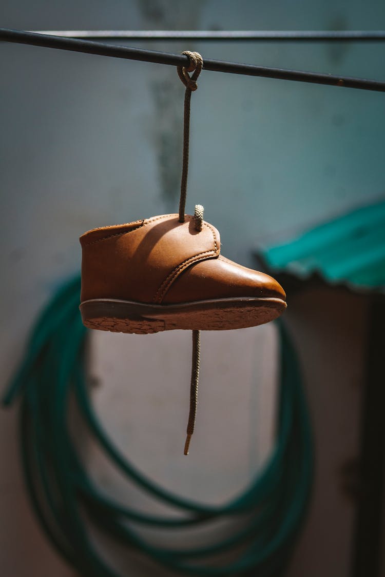 Old Baby Shoe Hanging On Rope