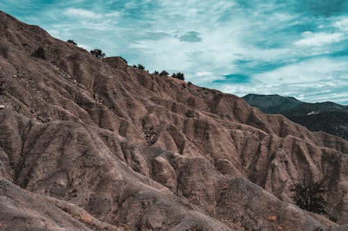 Brown Rocky Mountains Under Blue Sky