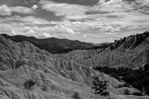 Free Monochrome photo of eroded rocky formations under a cloudy sky. Stock Photo