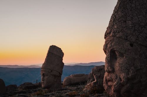 Free Ancient stone heads of Mount Nemrut, Adıyaman, Turkey, during a breathtaking sunset. Stock Photo