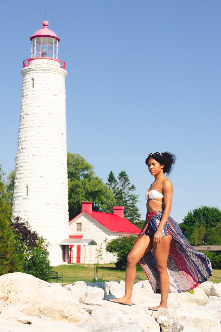 Woman In Bikini Posing Near Lighthouse