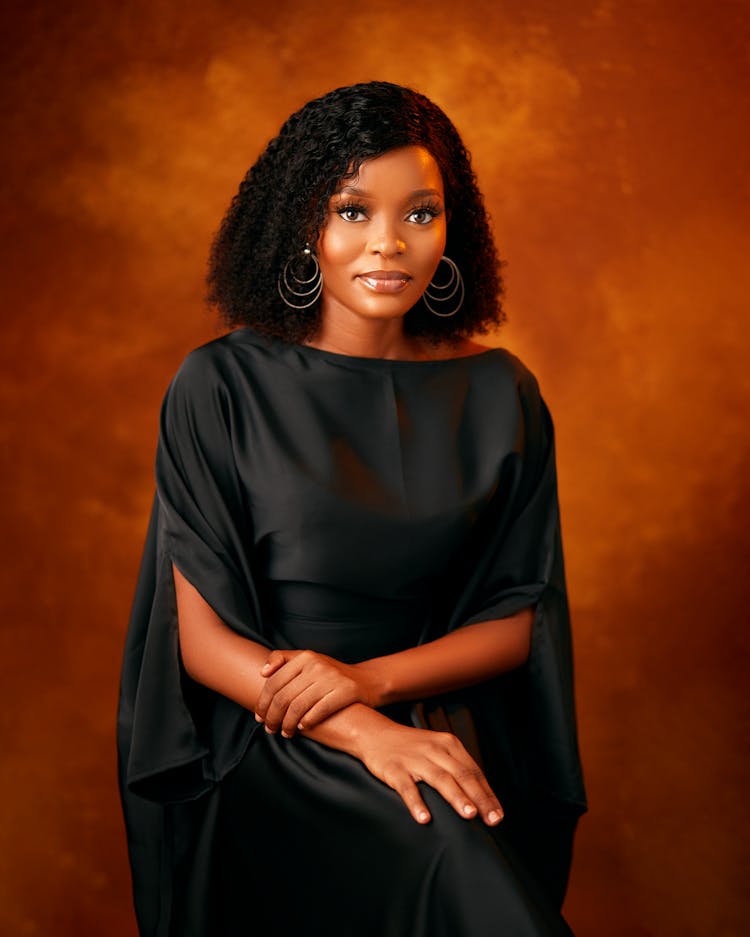 Smiling Pretty Girl Sitting In Loose Black Clothing