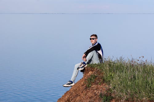 Man Sitting on a Cliff