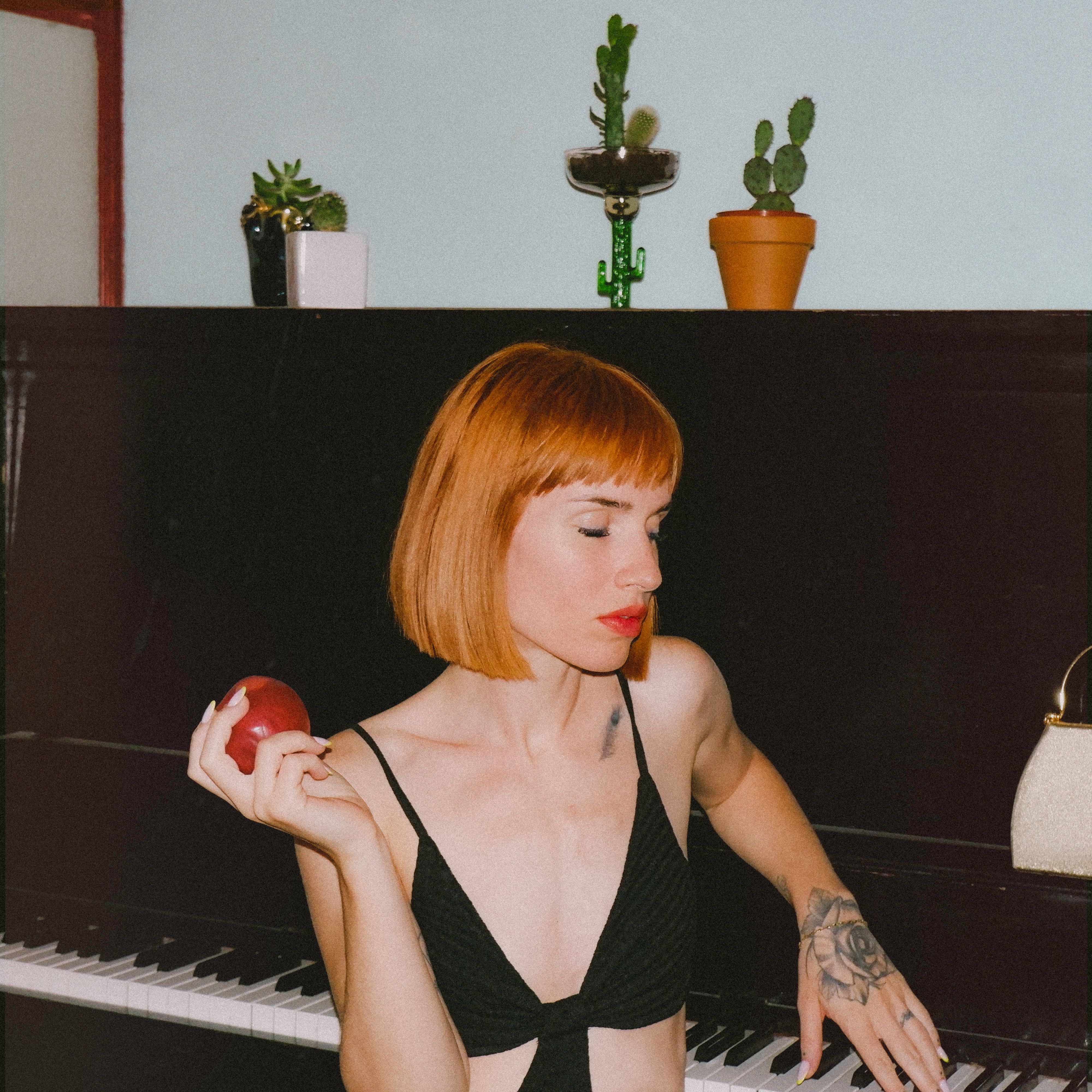 Close-up Photo of an Alluring Woman holding an Apple 