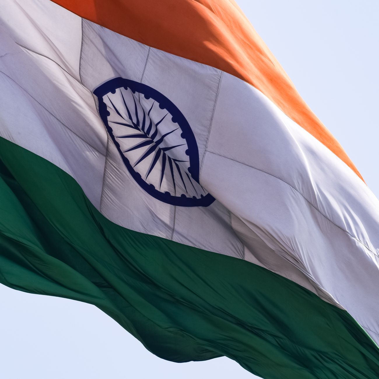 High-resolution image of the Indian flag waving on a clear day, symbolizing patriotism.