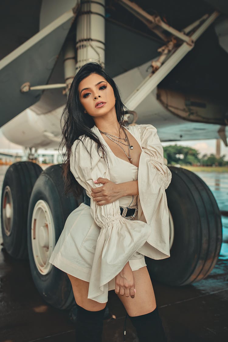 Woman In Front Of Airplane Wheel