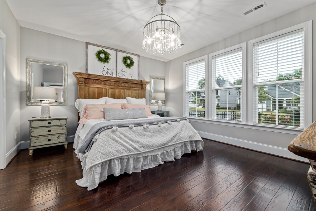 Classic bedroom inspo ideas with a wooden bed and elegant chandelier