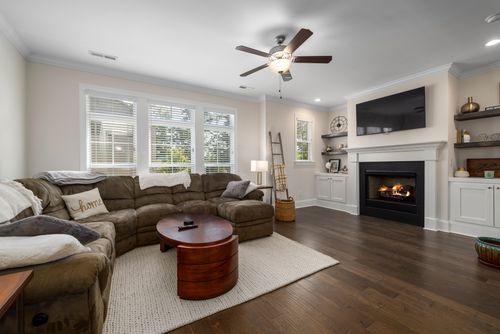 Free Inviting living room featuring a large sectional sofa and elegant fireplace, perfect for relaxation. Stock Photo