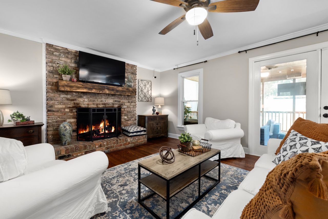 modern-farmhouse-living-room Modern farmhouse living room with stone fireplace, white sofas and wooden coffee table