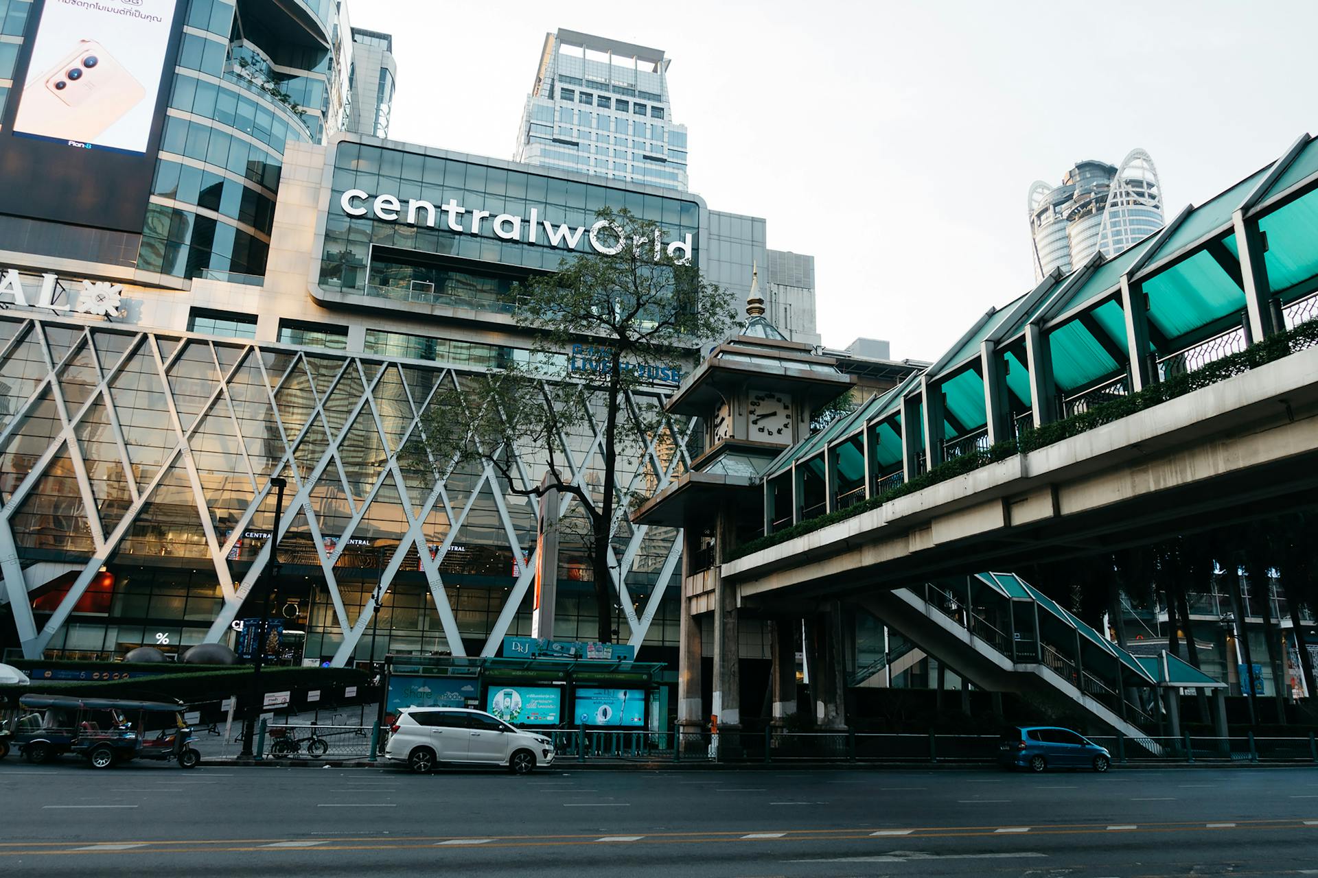 View of CentralWorld mall in Bangkok with a modern urban cityscape and highway traffic.