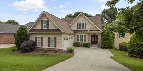 A beautiful suburban family house with a well-maintained lawn and driveway.