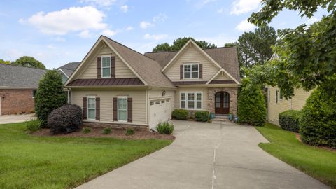 A beautiful suburban family house with a well-maintained lawn and driveway.