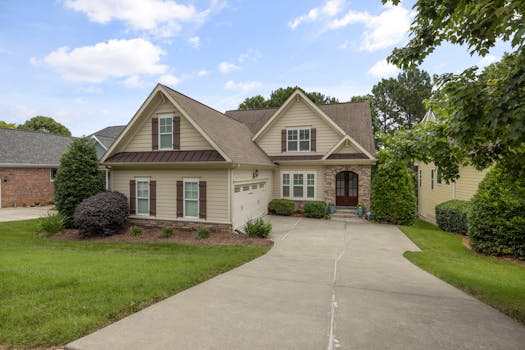 A beautiful suburban family house with a well-maintained lawn and driveway.
