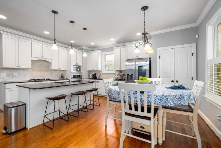 What Safety Research Reveals About Baby Proofing Cabinet Locks and Outlet Covers Spacious and elegant kitchen interior featuring a dining table and modern appliances, perfect for family gatherings.