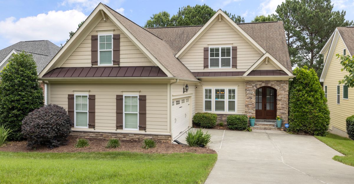 Beautiful suburban house with manicured lawn and modern architecture on a sunny day.