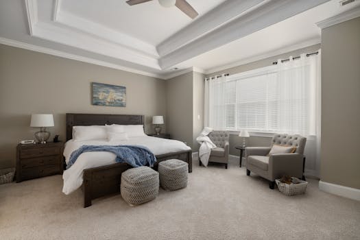 Spacious modern bedroom featuring cozy furniture, natural light, and elegant design elements.