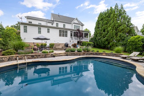 White Wooden House Near Swimming Pool