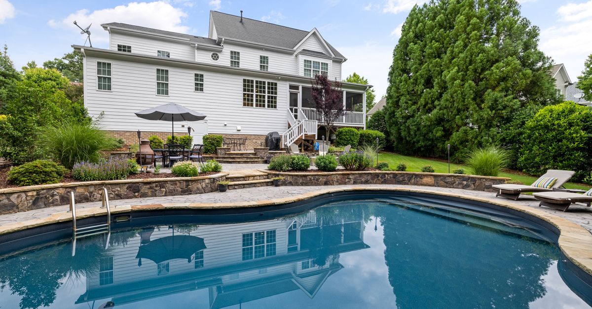 A beautiful suburban house with a pool and landscaped garden in a tranquil neighborhood.