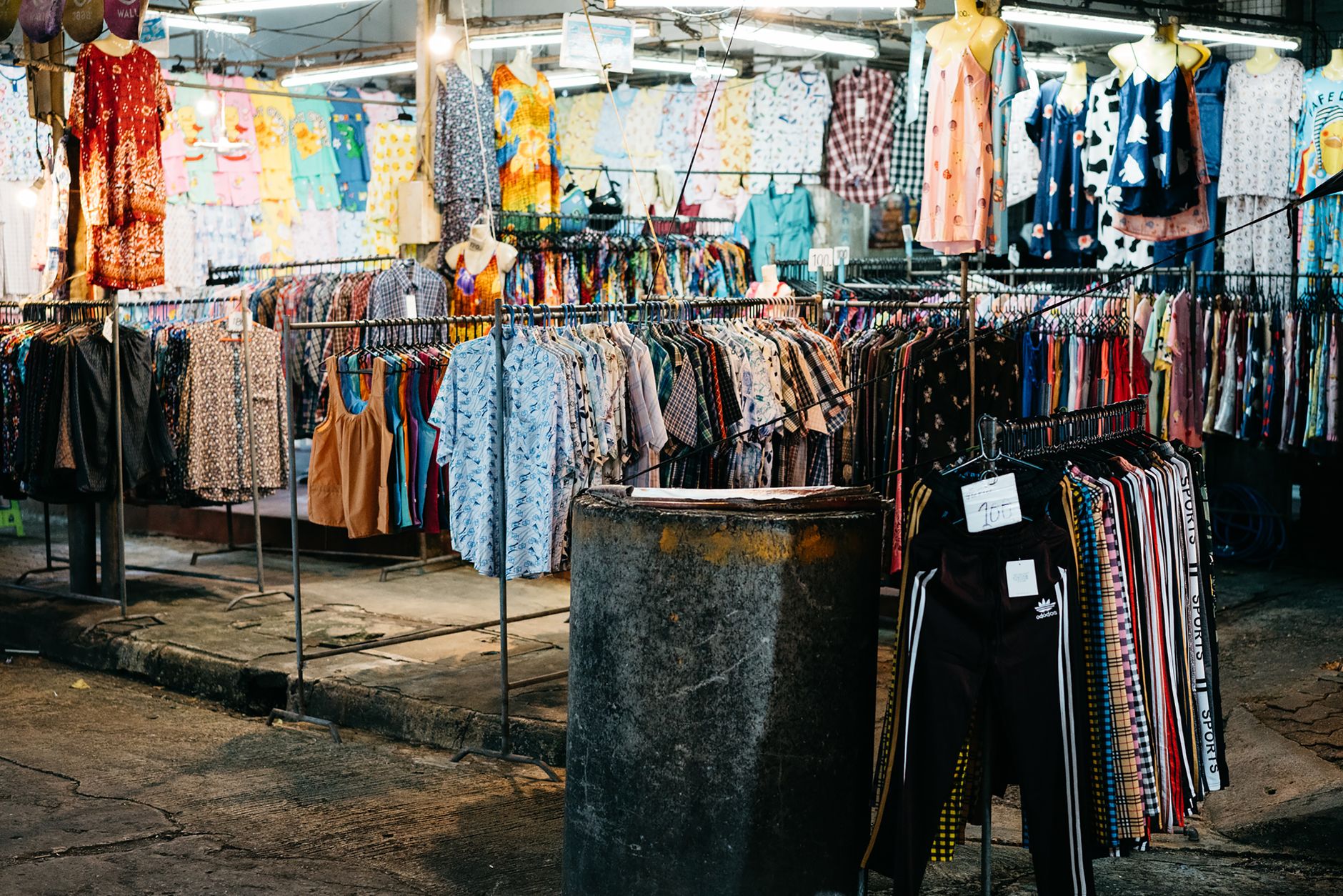 Rows of denim and vintage pieces hanging close together at a resale market