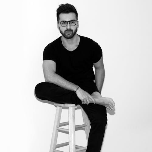 Man Cross Legs Seating on White Wooden Chair