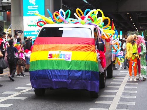 People and Cars on a Pride Parade 