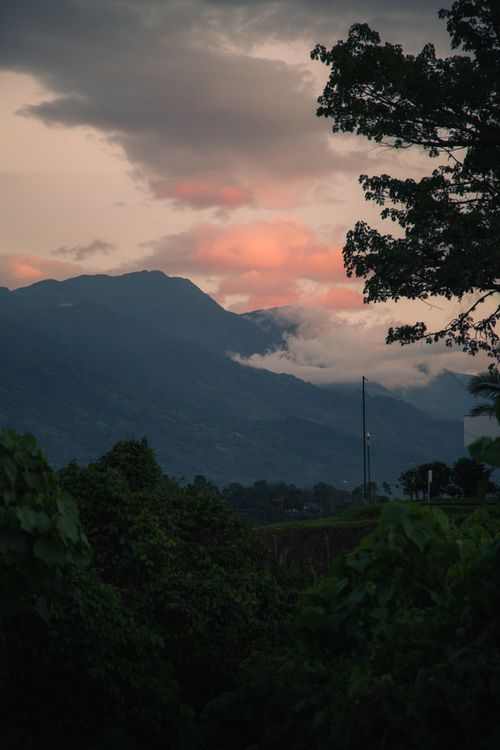 Free Captivating view of misty mountains under a vibrant sunset sky Stock Photo