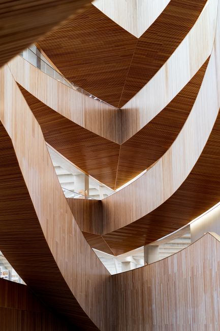 Elegant view of modern wooden staircase with unique architectural design features.