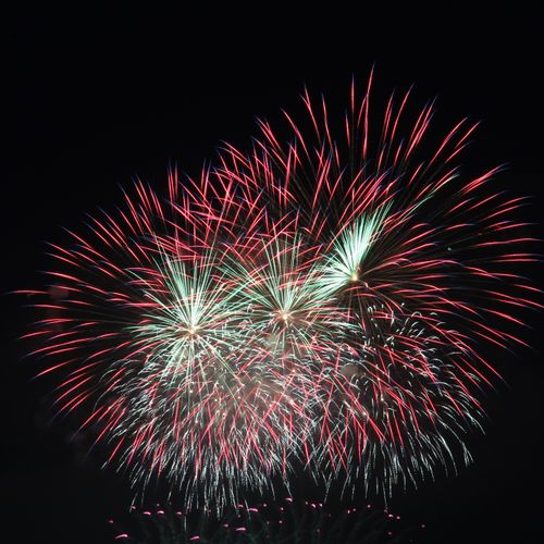 Free Beautiful display of colorful fireworks lighting up the night sky. Stock Photo