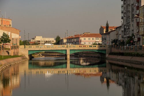 A Concrete Bridge over a Body of Water near Buildings