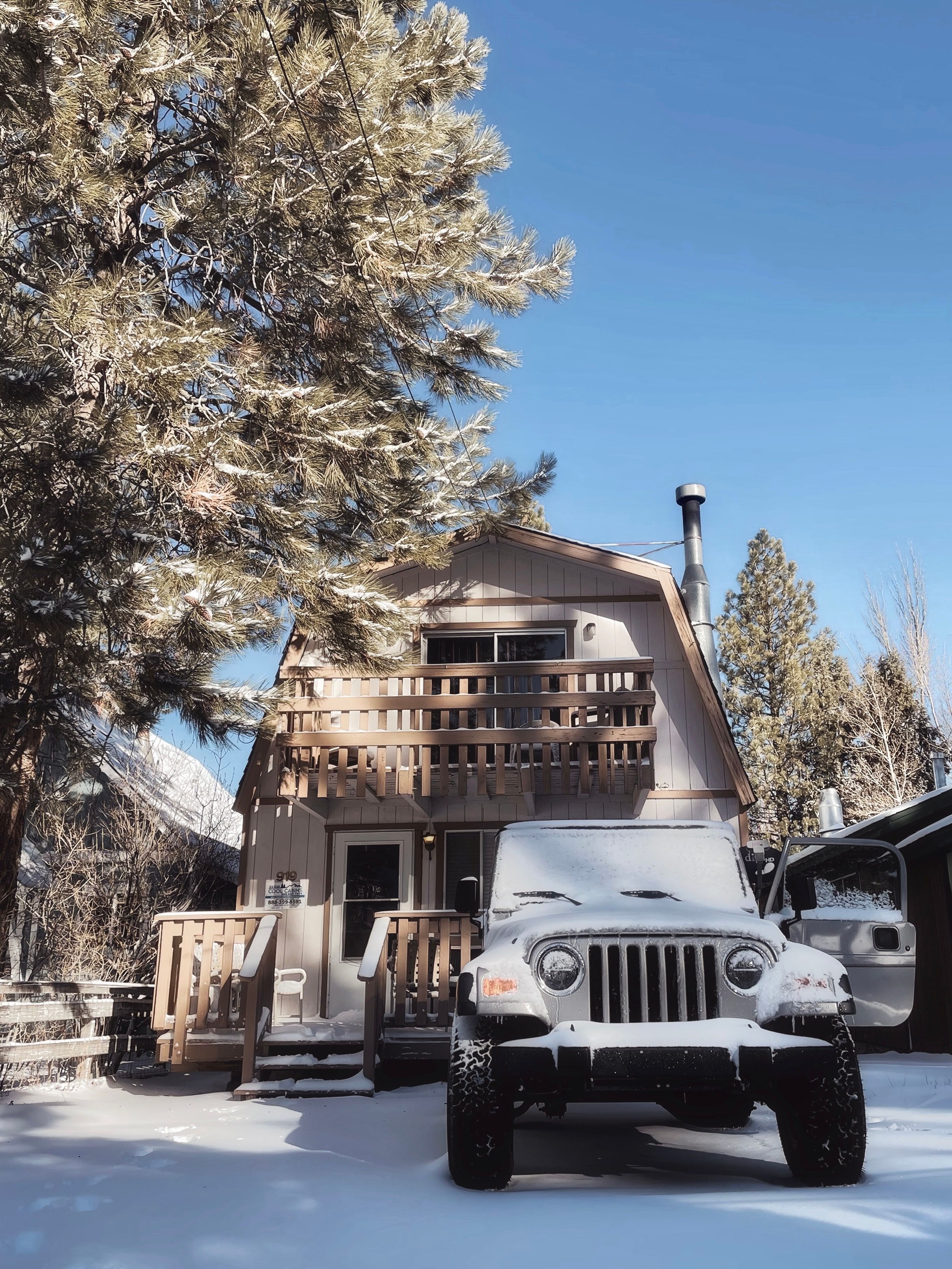 A Car Parked near a Wooden House during Winter · Free Stock Photo