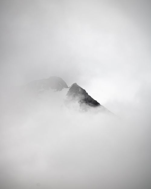 Free Enigmatic mountain peak emerging through dense clouds in Tirol, Austria, showcasing natural beauty. Stock Photo