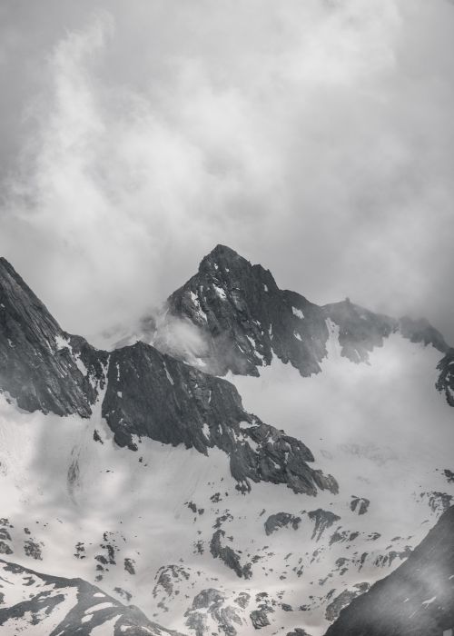 Free Stunning black-and-white aerial view of snow-covered mountains in Tirol, Austria. Stock Photo