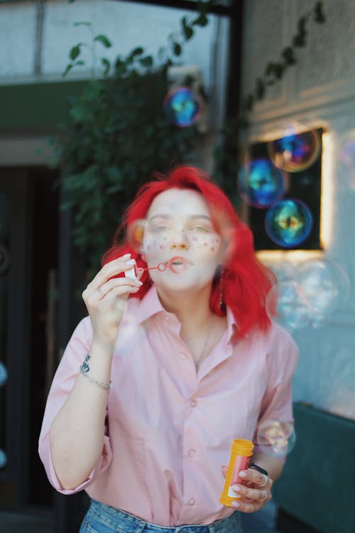 Woman in Pink Button Up Shirt With Red Hair