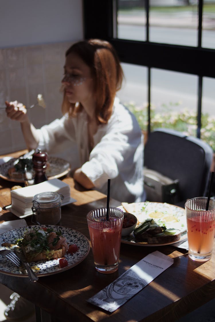 Woman Eating At A Restaurant