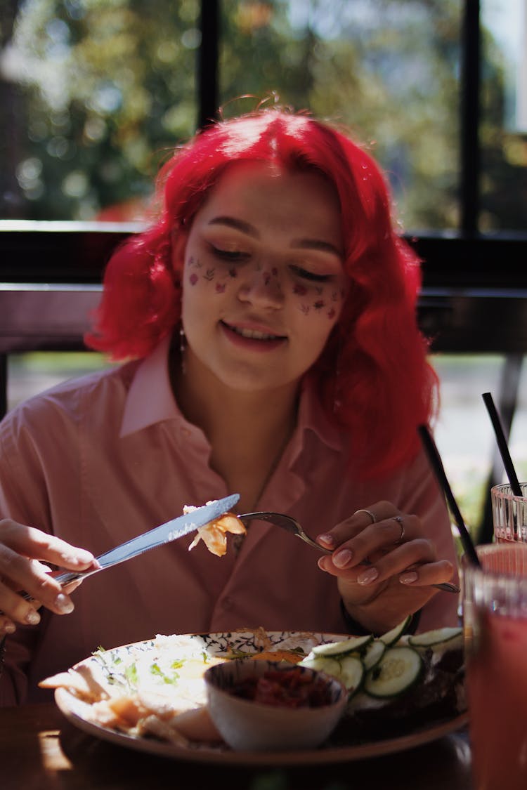 Woman In Pink Shirt Holding Fork And Knife