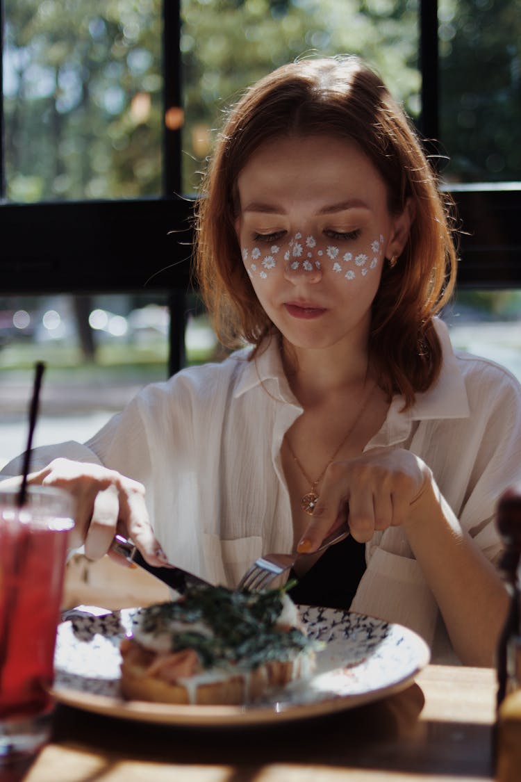 A Woman Eating In A Restaurant