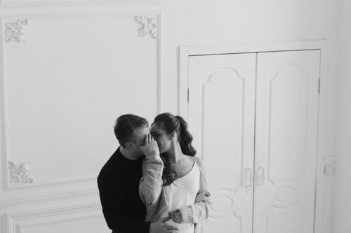 Free A couple sharing a tender moment indoors in a beautifully decorated room in Latvia. Stock Photo