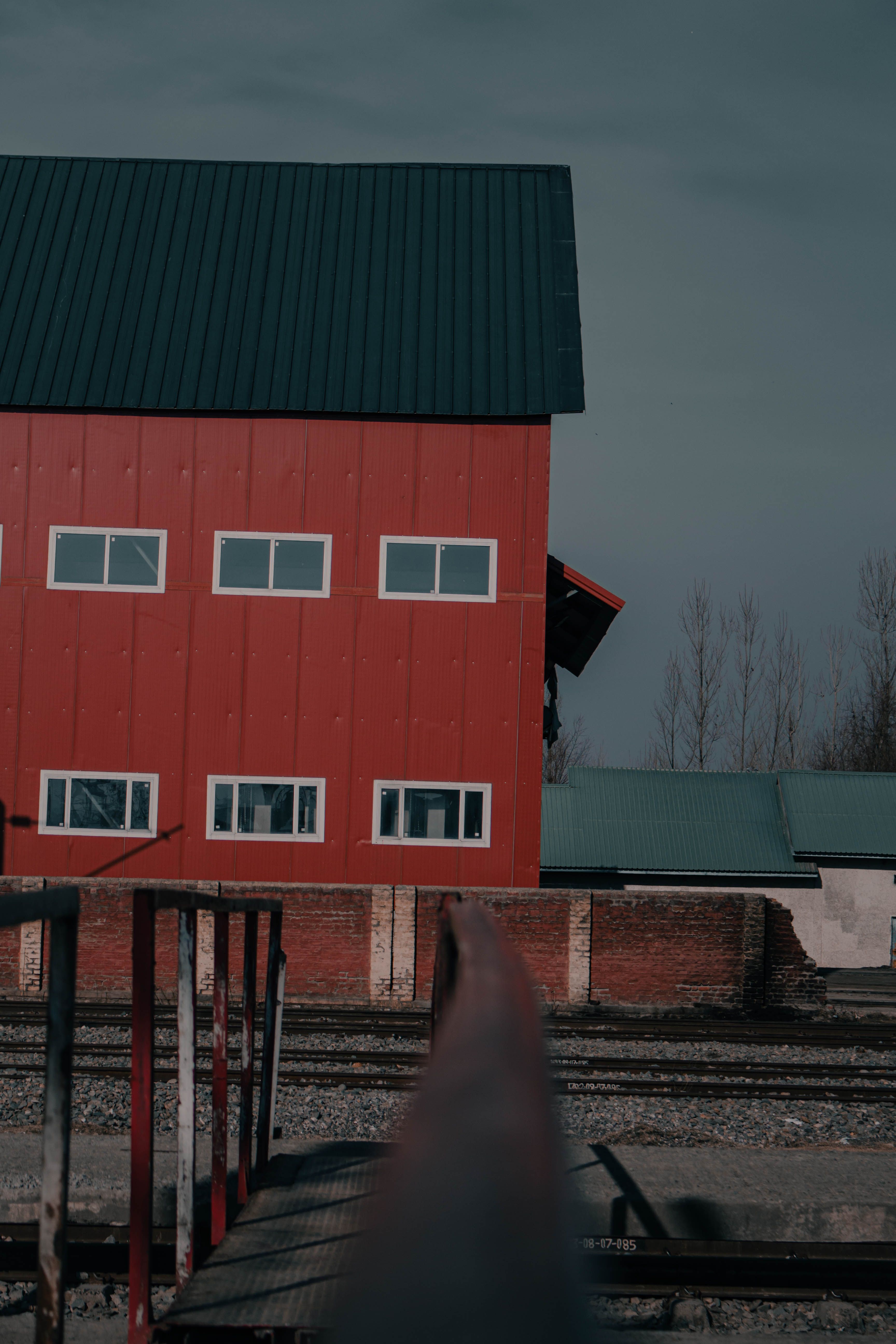 Red barndominium in the middle of the street