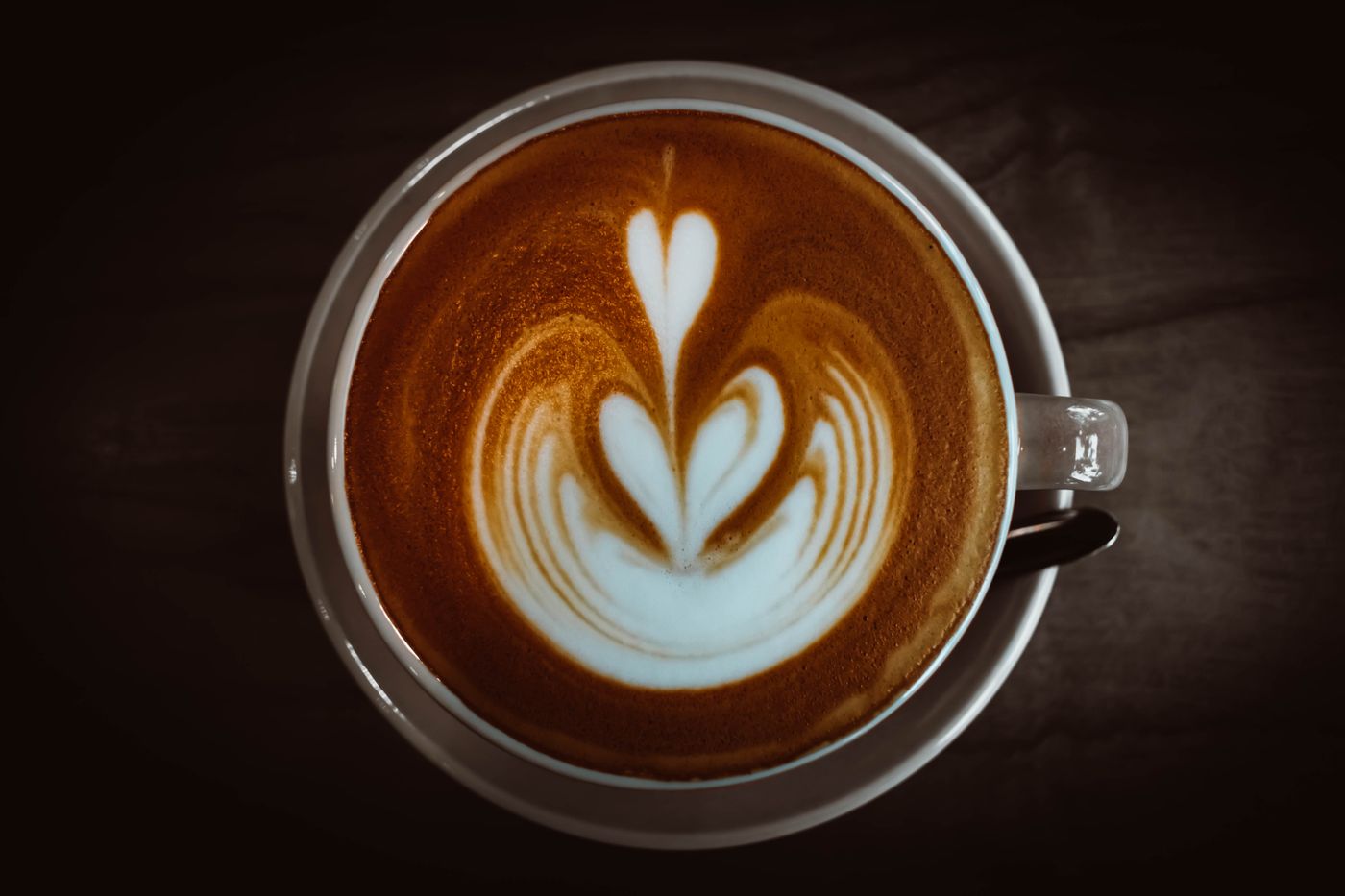 Freshly pulled cappuccino with heart-shaped latte art at Kopi & Co.
