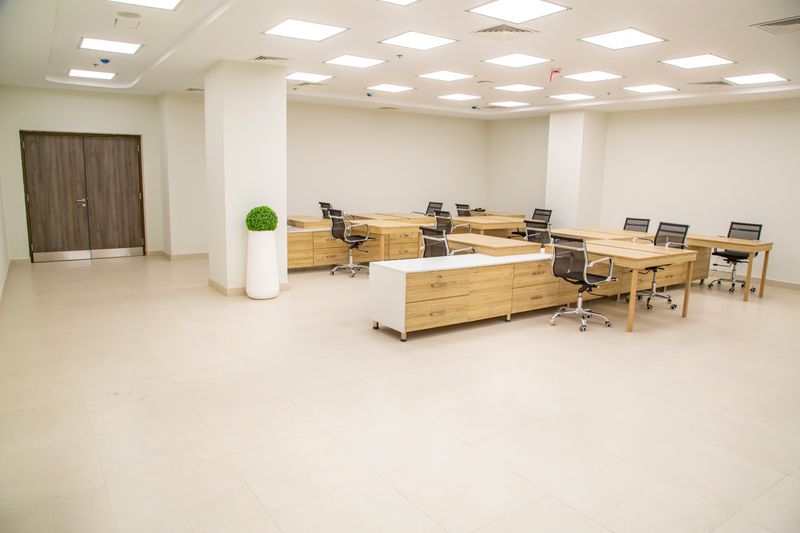 two matching wood desks with different colored chairs