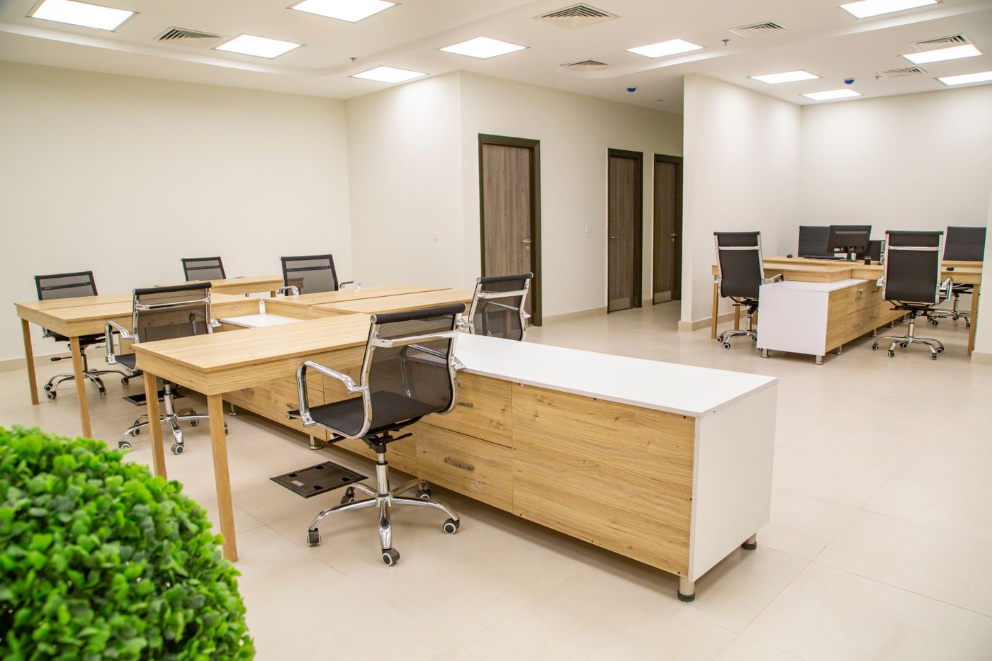 Office interior with wooden desks and task chairs