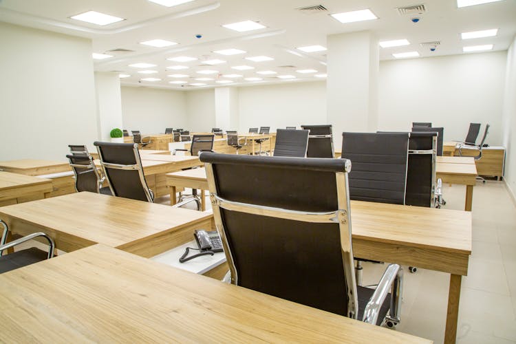 Chairs And Wooden Desks In An Office 