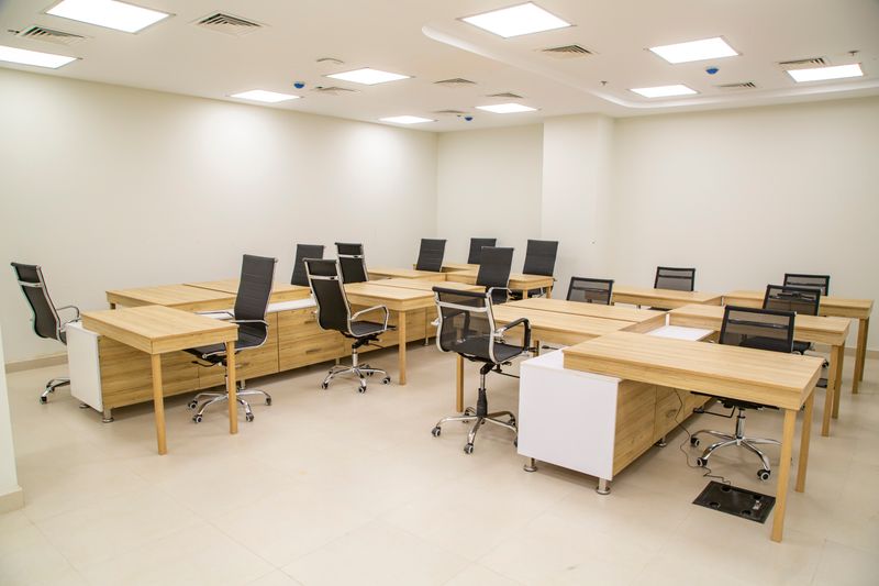 two different ergonomic chairs at matching desks