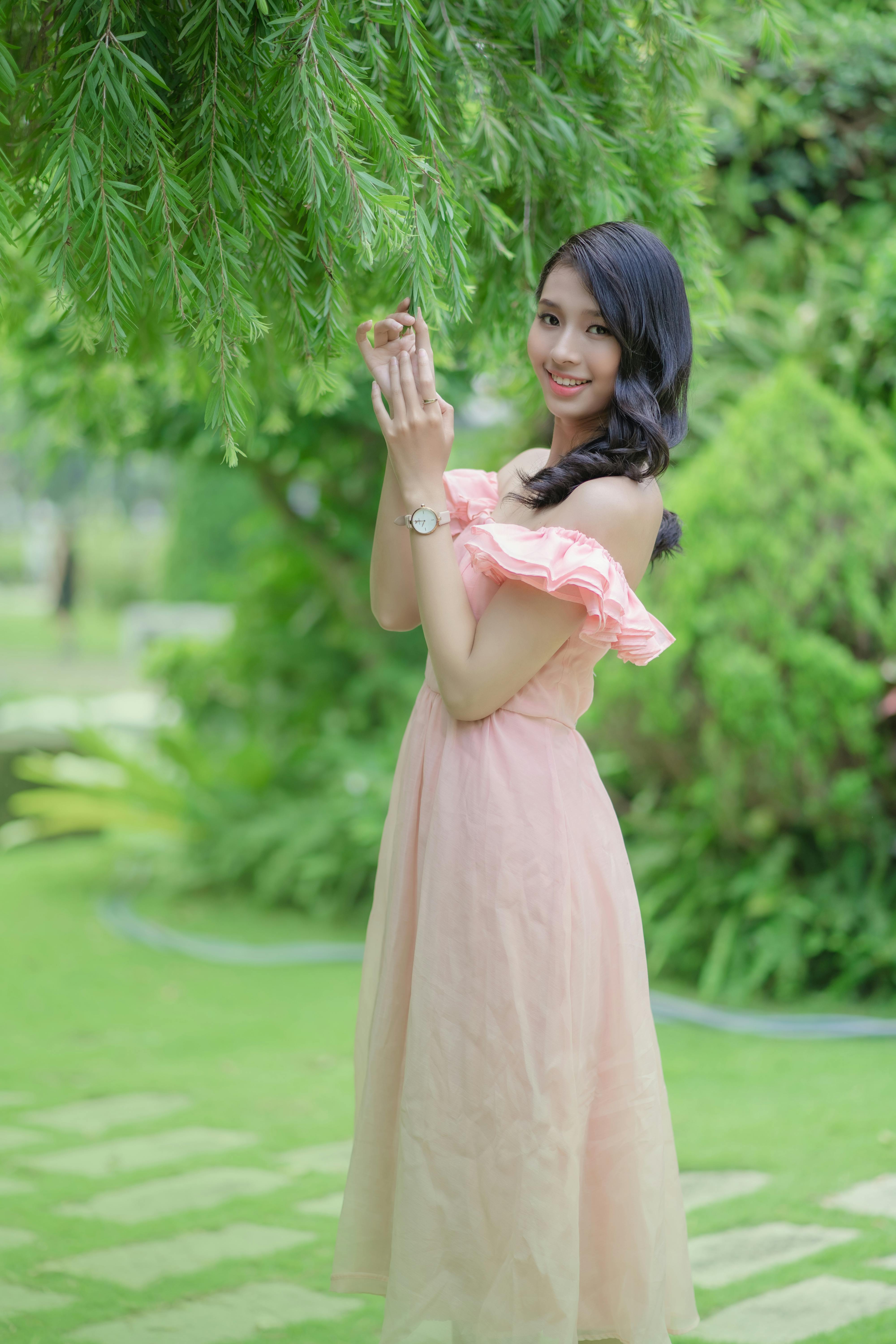 smiling woman in dress in park